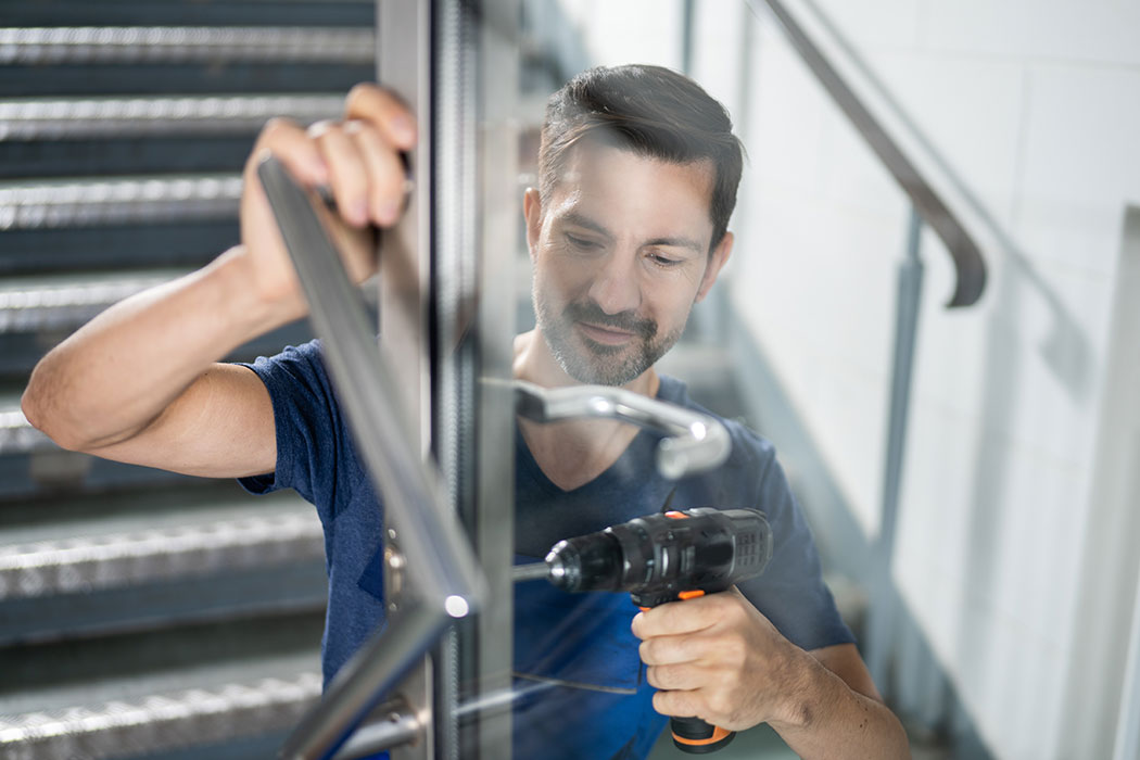 A technician fitting a door handle